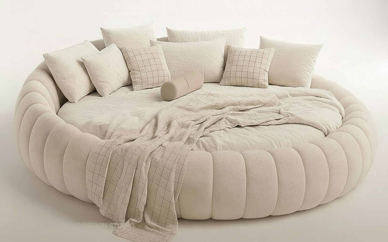 Round, beige sofa with cushions and a blanket on a white background
