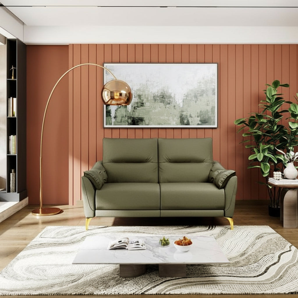 Modern living room with a green sofa, coffee table, and decorative elements.